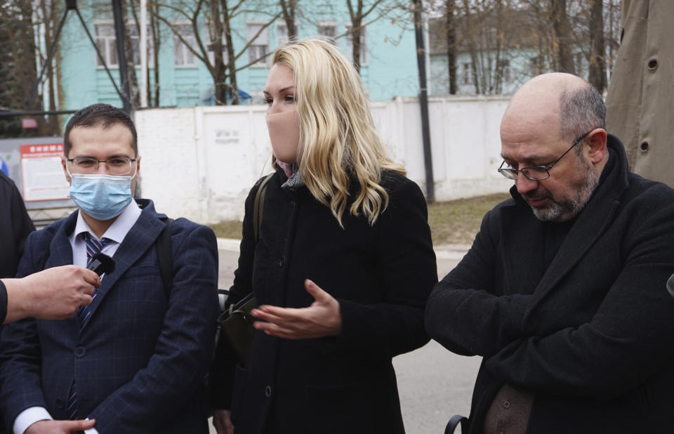 Cardiologist-therapist Yaroslav Ashikhmin, left, the head of Alliance of Doctors Anastasiya Vasilyeva, center, and anesthesiologist-resuscitator Alexey Erlikh speak to the media in front of the penal colony where a hospital for convicts located in Vladimir, a city 180 kilometers (110 miles) east of Moscow, Russia, Tuesday, April 20, 2021. Several doctors have been prevented from seeing Russian opposition leader Alexei Navalny at a prison hospital after his three-week hunger strike. Prosecutors, meanwhile, detailed a sweeping, new case against his organization. Navalny was transferred Sunday from a penal colony east of Moscow to a prison hospital in Vladimir, east of the capital, and his lawyers and associates have said that his condition has dramatically worsened. Reports about his rapidly deteriorating health has drawn international outrage. One of his personal physicians, Dr. Anastasia Vasilyeva, led three other medical experts to try to visit Navalny, but they were denied entry after waiting for hours outside the gates. (AP Photo/Kirill Zarubin)