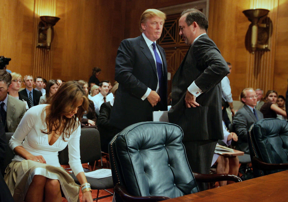Donald Trump, then president of the Trump Organization, talks to Christopher Burnham, undersecretary general of the U.N. Department of Management, after Trump testified before a&nbsp;Senate Homeland Security and Governmental Affairs subcommittee on July 21, 2005, as his wife, Melania, accompanied him. (Photo: Joe Raedle via Getty Images)
