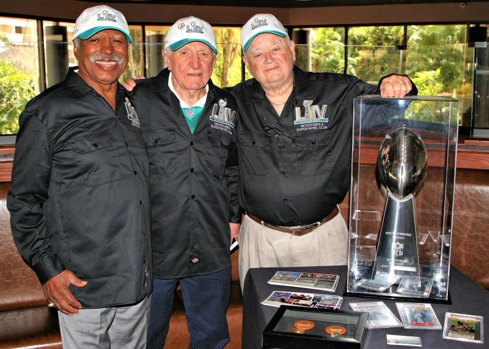 Greg Eaton of Lansing, left, joins  Tom Henschel of Pittsburgh and Florida and Don Crisman of Maine, all  members of the Never Miss A Super Bowl Club.