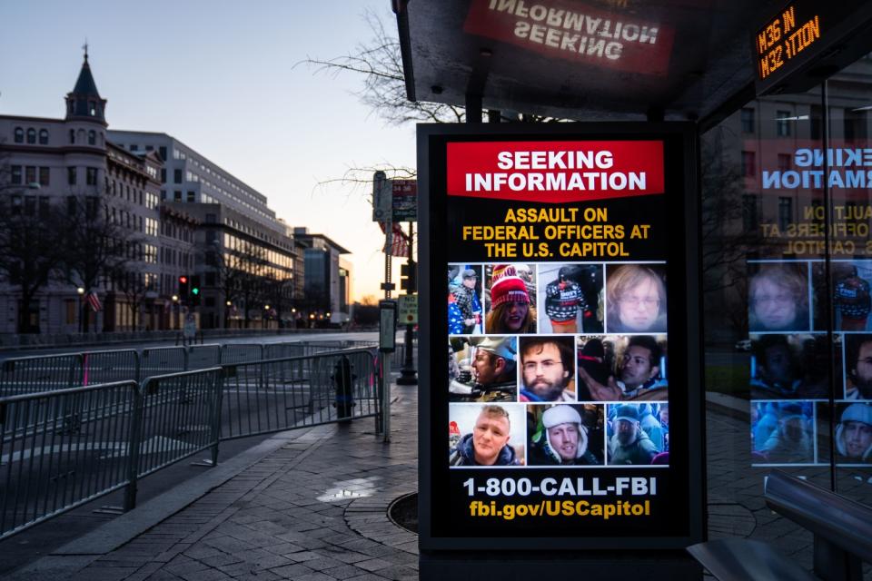 Signs at bus stations ask for information about people who breached the U.S. Capitol on Jan. 6.