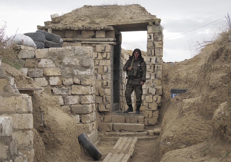 An Ethnic Armenian soldier walks at a fighting position on the front line, during a military conflict against Azerbaijan's armed forces in the separatist region of Nagorno-Karabakh, Wednesday, Oct. 21, 2020. Armenia's prime minister has urged citizens to sign up as military volunteers to help defend the country amid the conflict with Azerbaijan over the disputed territory of Nagorno-Karabakh as intense fighting has raged for a fourth week with no sign of abating. (AP Photo)