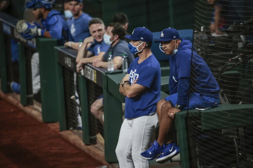 Arlington, Texas, Sunday, October 11, 2020. Dodgers manager Dave Roberts and coach Bob Geren watch batting practice the night before game one of the NLCS at Globe Life Field. (Robert Gauthier/ Los Angeles Times)