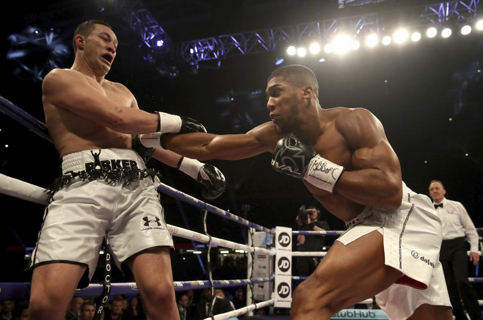 Anthony Joshua (R) battles against Joseph Parker during their WBA, IBF and WBO heavyweight champion at the Principality Stadium in Cardiff, Wales, Saturday March 31, 2018. (AP)