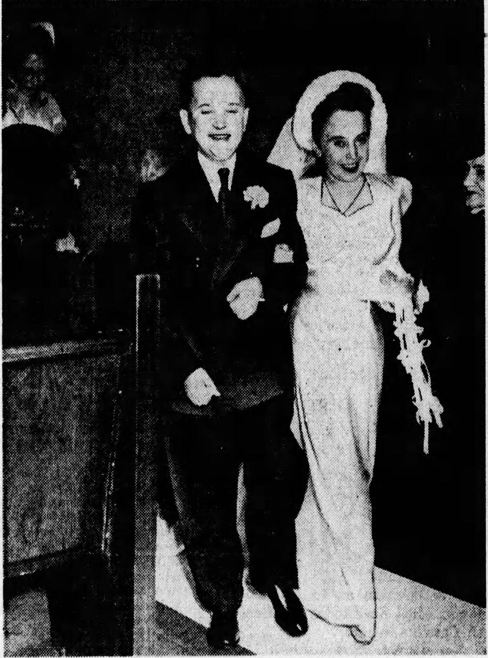Meinhardt Raabe walks down the aisle with his wife, Marie, after their wedding Dec. 15, 1946, in Akron.