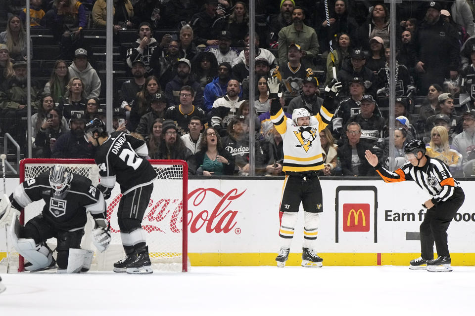 Pittsburgh Penguins defenseman Erik Karlsson, second from right, celebrates an overtime goal by right wing Bryan Rust as Los Angeles Kings goaltender Pheonix Copley, left, and center Phillip Danault stand in goal during the third period of an NHL hockey game Thursday, Nov. 9, 2023, in Los Angeles. (AP Photo/Mark J. Terrill)
