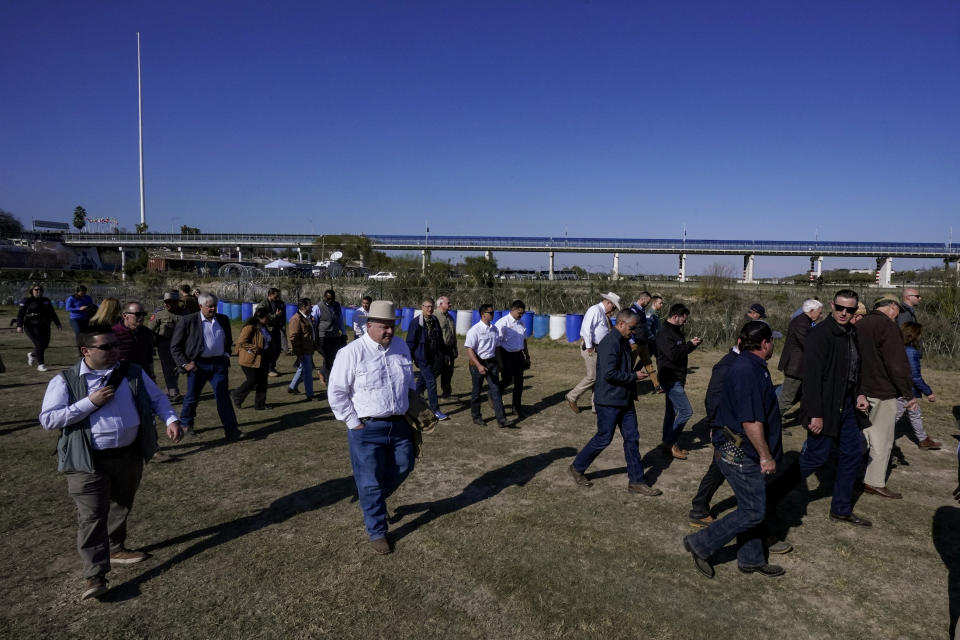 Republican members of Congress walk adjacent to the Rio Grande at the Texas-Mexico border, Wednesday, Jan. 3, 2024, in Eagle Pass, Texas. U.S. House Speaker Mike Johnson is leading about 60 fellow Republicans in Congress on a visit to the Mexican border. Their trip comes as they are demanding hard-line immigration policies in exchange for backing President Joe Biden's emergency wartime funding request for Ukraine. (AP Photo/Eric Gay)