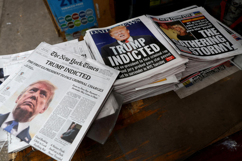 New York newspapers are displayed at a newsstand