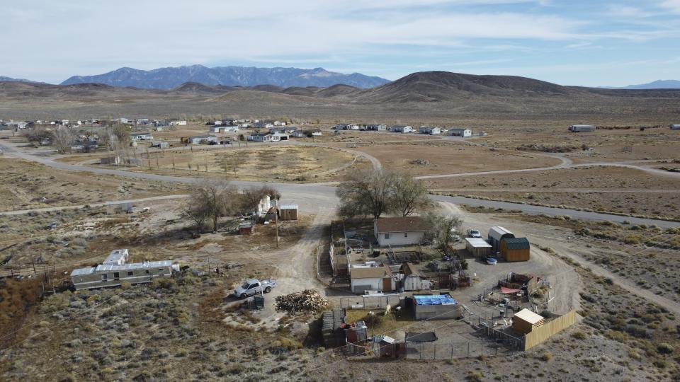 Homes sit at the Duckwater Reservation on Nov. 11, 2023, near the Big Warm Spring, Nev. A coalition of three tribes in the Great Basin region want the Bahsahwahbee massacre site named a national monument. (AP Photo/Rick Bowmer)