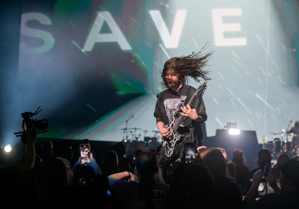 Weston Evans, guitarist for Christian rock band Seventh Day Slumber, gets up close and personal with the crowd during a performance at the Winter Jam 2024 tour March 14 at the Peoria Civic Center in Peoria, Illinois.