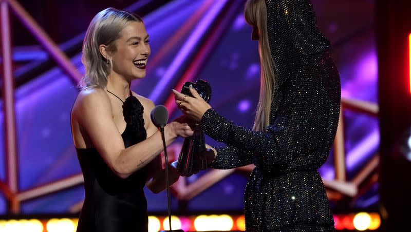 Phoebe Bridgers, left, presents Taylor Swift with the Innovator award at the iHeartRadio Music Awards on Monday, March 27, 2023, at the Dolby Theatre in Los Angeles. 