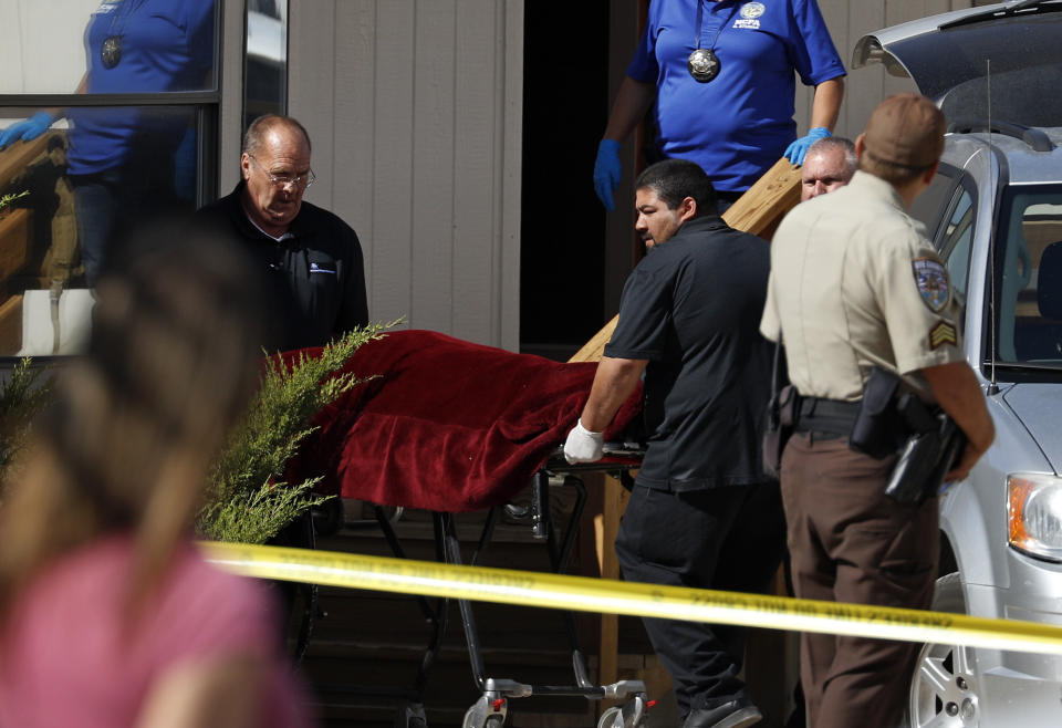 Authorities remove the body of Nevada brothel owner Dennis Hof from the Love Ranch brothel, Tuesday, Oct. 16, 2018, in Pahrump, Nev. Hof, a legal pimp and Republican candidate. died Tuesday Nevada Authorities said. (AP Photo/John Locher)