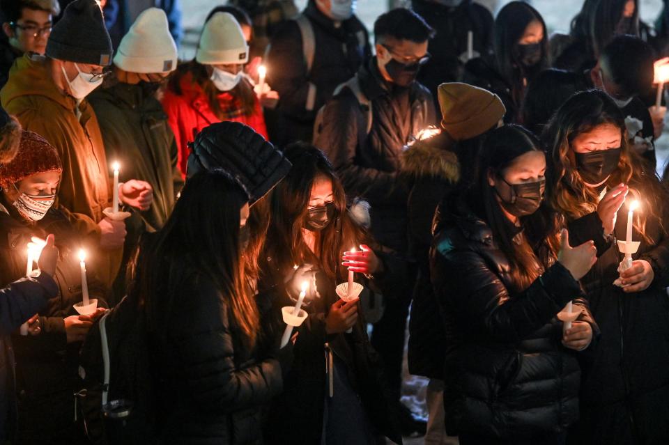 Participants observe a moment of silence during a vigil for MSU student Phat Nguyen on Monday, Nov. 29, 2021, outside the Eli Broad College of Business on the MSU campus in East Lansing. Nguyen died about 2 weeks ago at a fraternity house on Stoddard Ave. He'd been pledging Pi Alpha Phi.