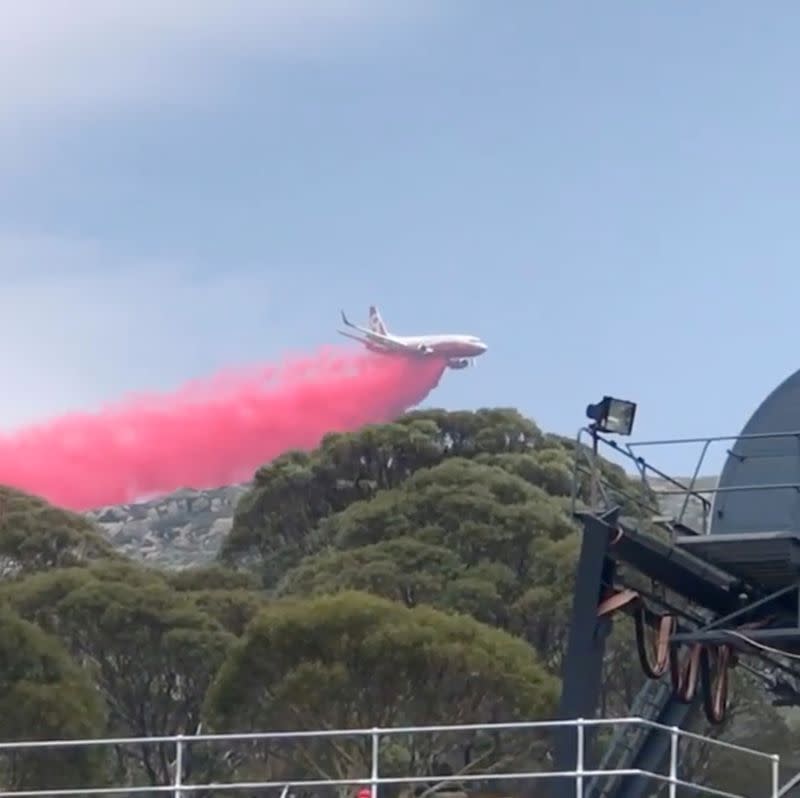 A plane releases fire retardant on an area in Perisher Valley, New South Wales, Australia, in this January 10, 2020 still frame obtained from social media video.