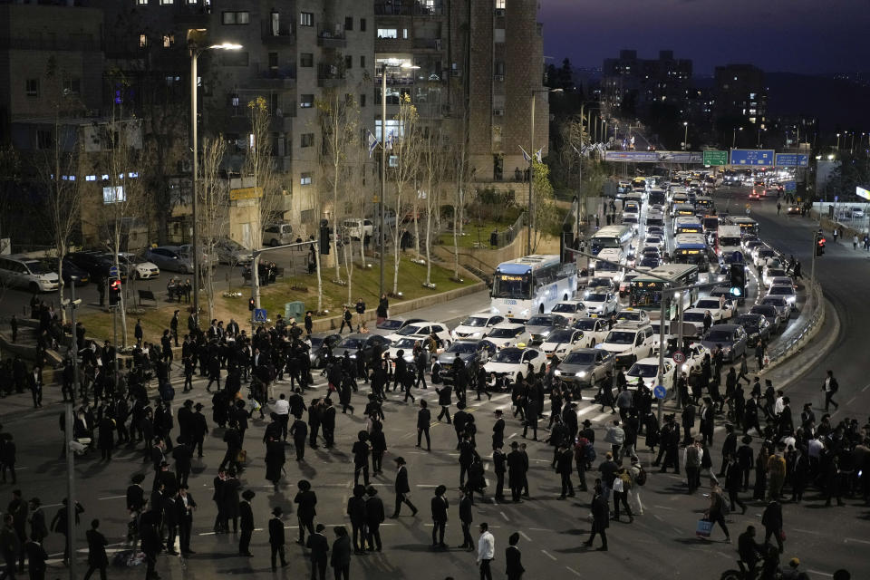 FILE - Ultra-Orthodox Jewish men and boys block a road during a protest against the country's military draft in Jerusalem, on Feb. 26, 2024. Israel's High Court ruling Thursday to curtail subsidies for ultra-Orthodox men has thrown Prime Minister Benjamin Netanyahu's political future into grave jeopardy. Netanyahu now has until Monday to present the court with a plan to dismantle what the justices called a system that privileges the ultra-Orthodox at the expense of the country's majority. (AP Photo/Leo Correa, File)