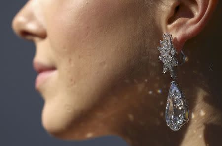 An assistant poses with Miroir de l'Amour, a pair of flawless diamond pear-shaped earrings, during a sale at a photocall a sale preview at Christie's auction house in London, Britain October 20, 2016. REUTERS/Neil Hall