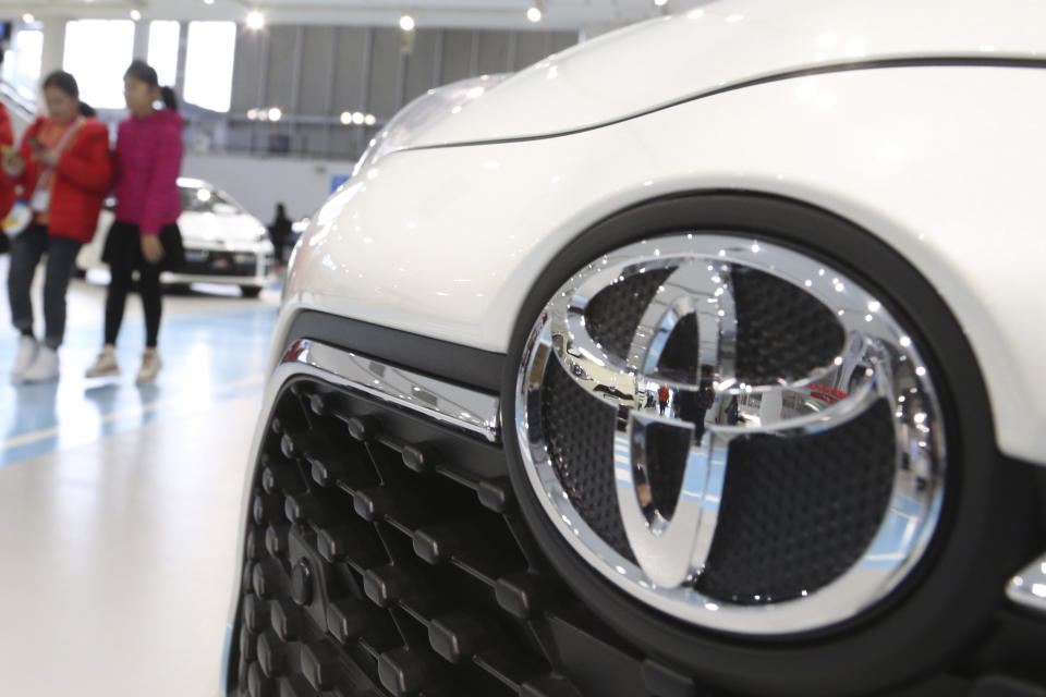 Visitors walk at Toyota Motor Corp.'s gallery in Tokyo on Jan. 15, 2020. Toyota’s April-June profit plunged 74% as the coronavirus pandemic crushed vehicle sales to about half of what the top Japanese automaker sold the previous year, reported Thursday, Aug. 6, 2020. (AP Photo/Koji Sasahara)