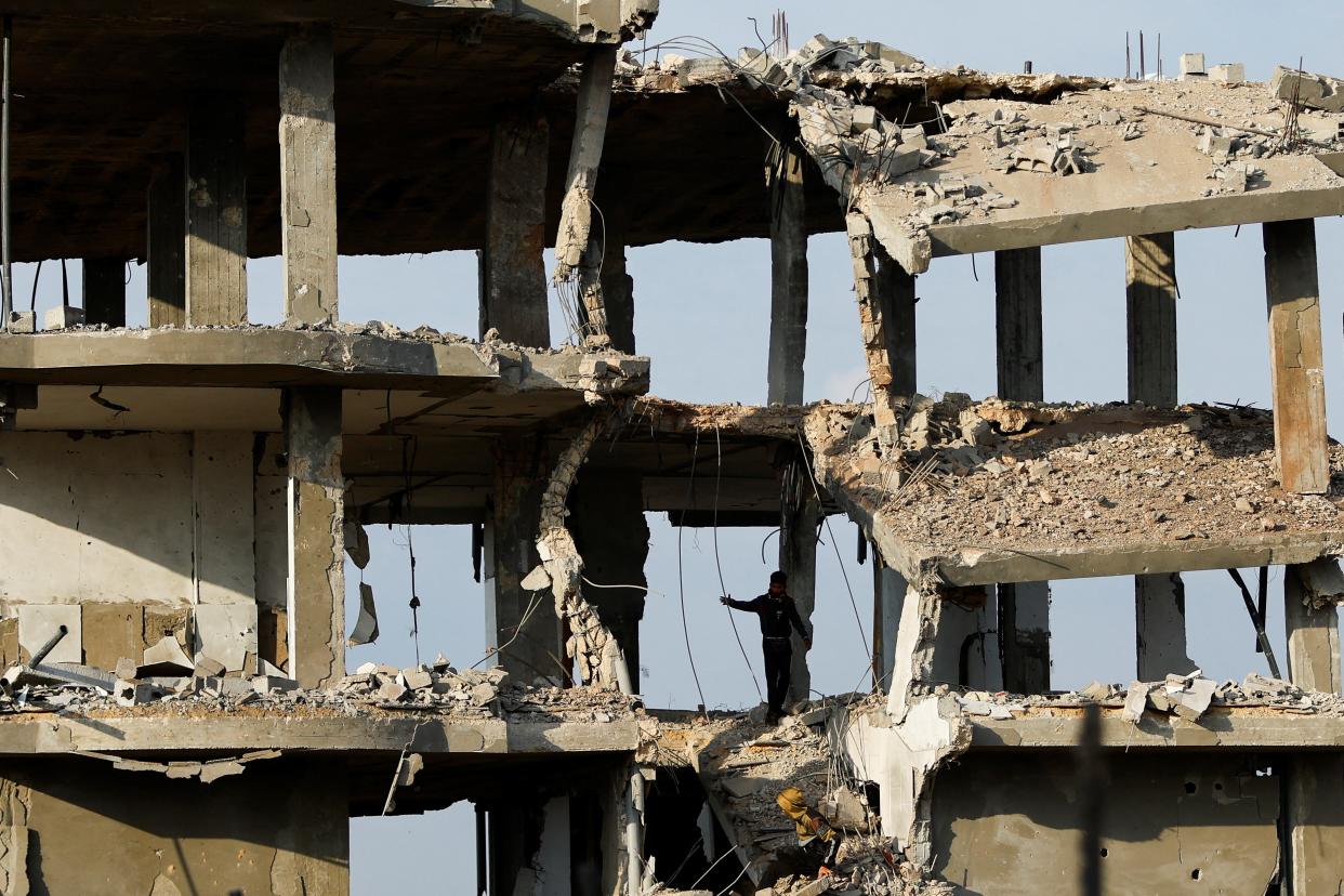 A Palestinian boy walks through the rubble of a damaged house hit by Israeli strikes in the southern Gaza Strip on Wednesday (REUTERS)