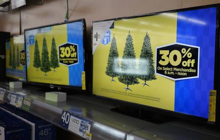 The special Black Friday prices are shown on TVs for sale at Walmart on Black Friday in Broomfield, Colorado November 28, 2014. REUTERS/Rick Wilking