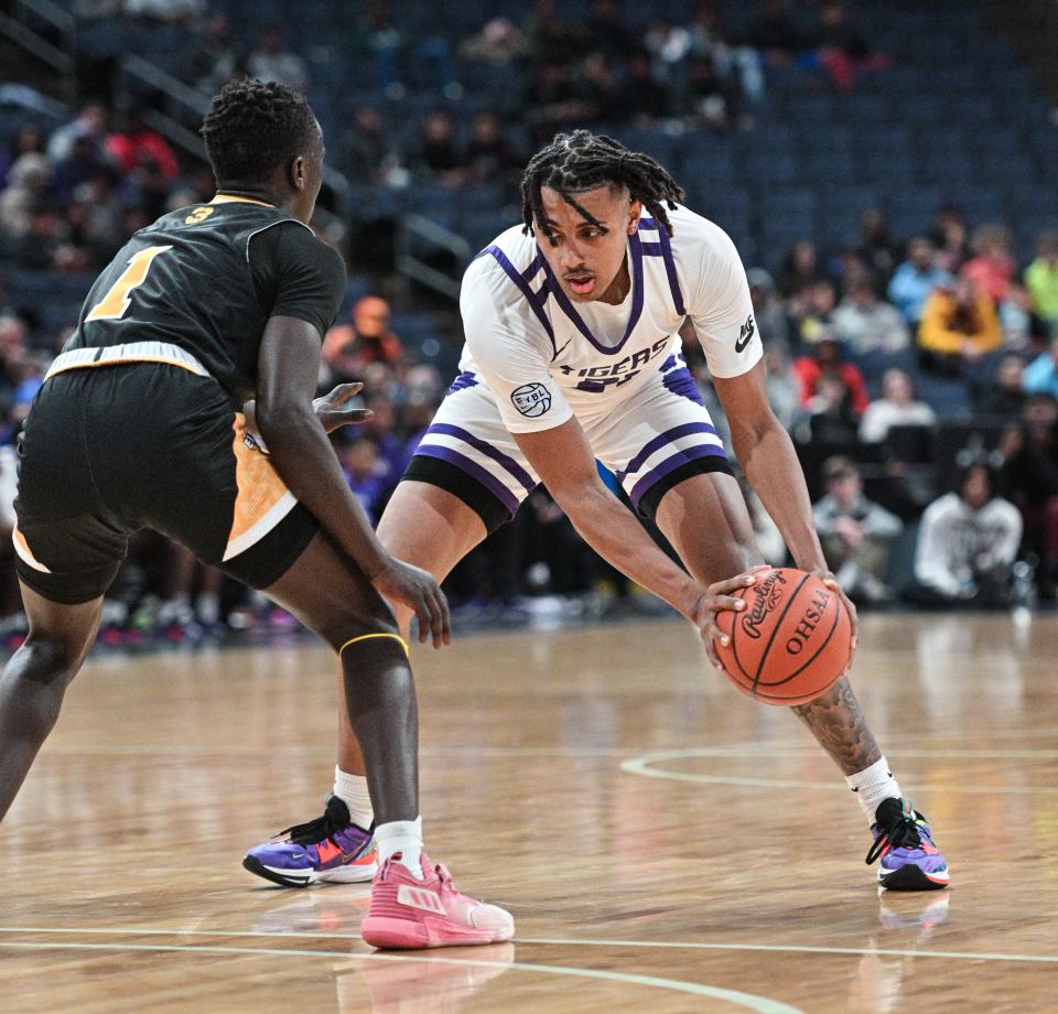 Pickerington Central's Devin Royal works against Centerville's Emmanuel Deng during the Ohio Play-by-Play Classic on Dec. 17 at Nationwide Arena.