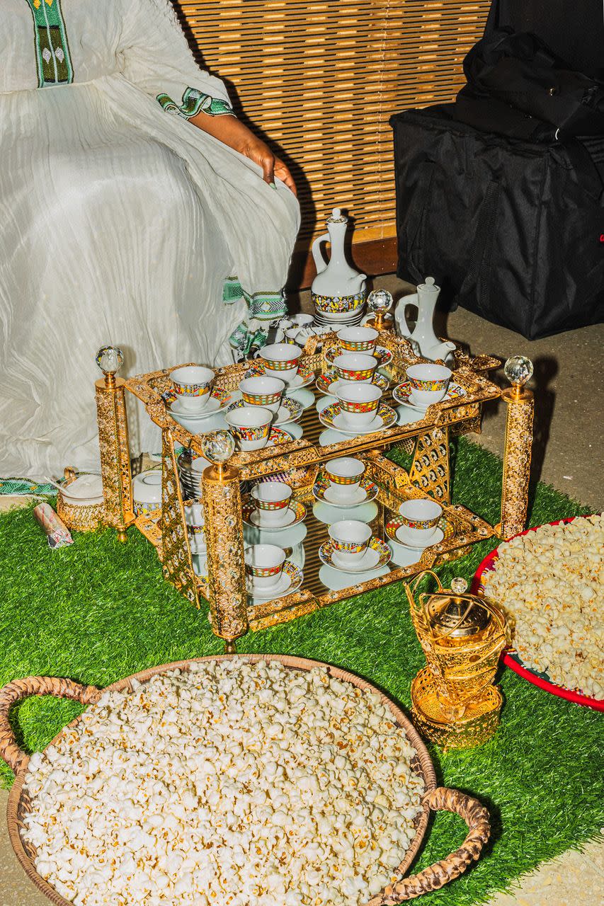 a table with a vase and cups on it