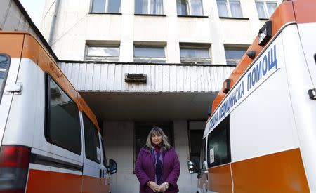 Bulgarian doctor Irena Marinova poses for a picture near ambulances at a hospital in the town of Botevgrad January 12, 2015. REUTERS/Stoyan Nenov