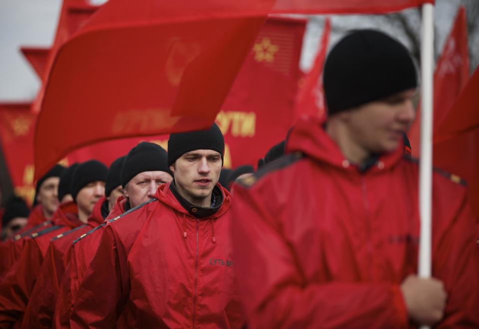 Demonstrators wearing red march in support of Kremlin-backed plans for the Ukrainian province of Crimea to break away and merge with Russia, in Moscow, Saturday, March 15, 2014. Large rival marches have taken place in Moscow over Kremlin-backed plans for Ukraine’s province of Crimea to break away and merge with Russia. The marchers belong to a group calling itself the “Essence of Time,” which professes to militate in the interests of social progress in Russia and protect the interests of Russians. (AP Photo/Alexander Zemlianichenko)