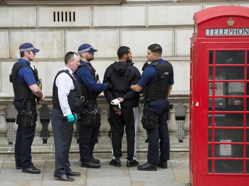 A man is detained by police officers near Downing Street (Getty Images)