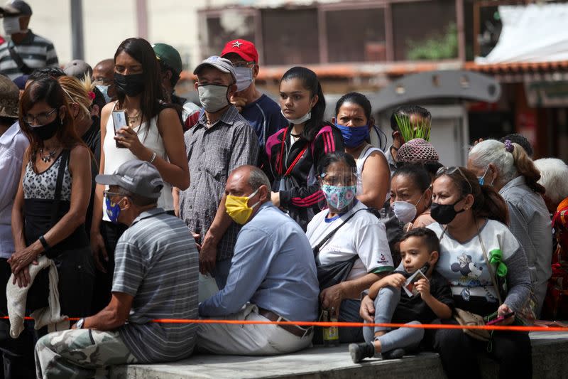 People gather outside of the Our Lady of La Candelaria church in Caracas