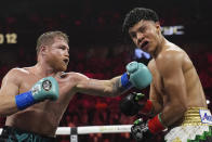 Canelo Alvarez hits Jaime Munguia in a super middleweight title fight Saturday, May 4, 2024, in Las Vegas. (AP Photo/John Locher)