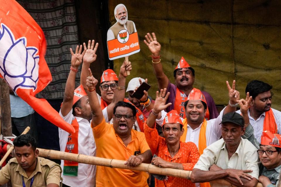 Supporters cheer to welcome Modi during a roadshow ahead of the last phase of elections in Kolkata, India on Tuesday (AP)