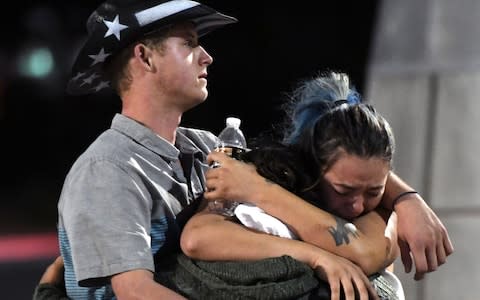 People hug and cry outside the Thomas & Mack Center after a mass shooting at the Route 91 Harvest country music festival  - Credit: Ethan Miller/Getty