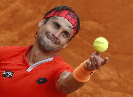 David Ferrer of Spain serves during his match against Gilles Simon of France at the Monte Carlo Masters in Monaco in this file photo taken on April 16, 2015. REUTERS/Eric Gaillard
