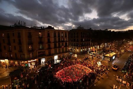 People gather at an impromptu memorial where a van crashed into pedestrians at Las Ramblas in Barcelona, Spain, August 20, 2017. REUTERS/Susana Vera