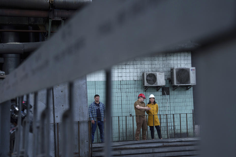 German's Foreign Minister Annalena Baerbock speaks to Ukrainian Energy Minister Herman Halushchenko during official visit to a thermal power plant which was destroyed by a Russian rocket attack in Ukraine, Tuesday, May 21, 2024. (AP Photo/Evgeniy Maloletka)