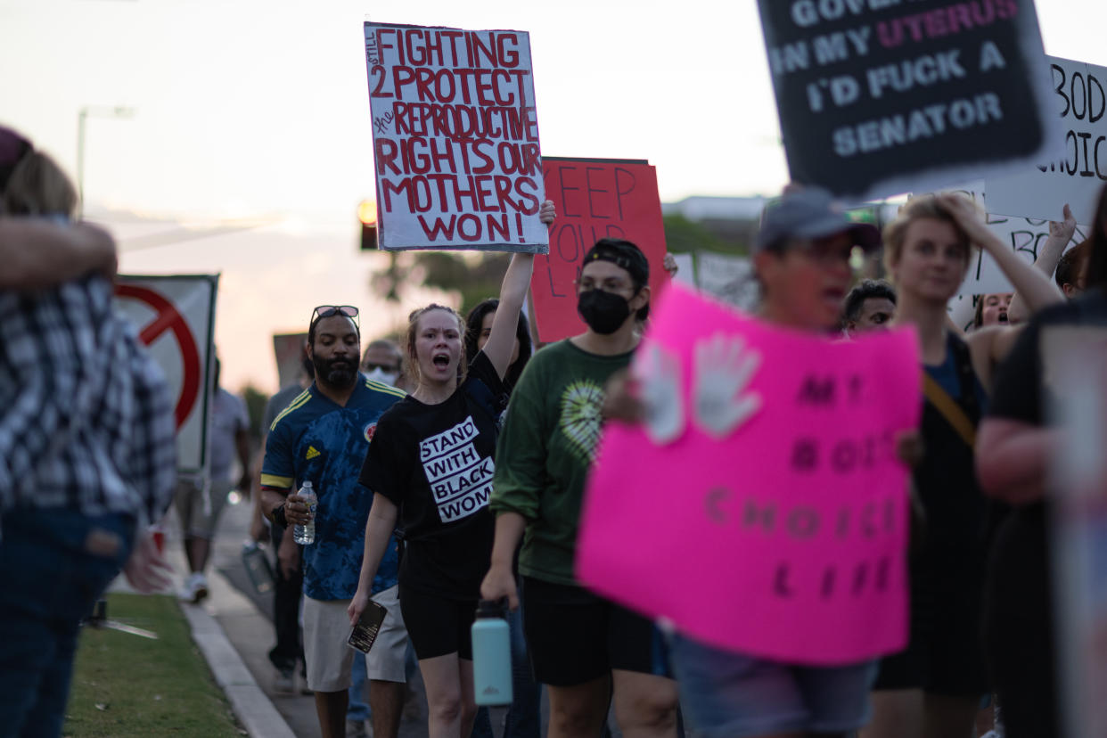 Women march in Phoenix march holding signs that read: My Body Choice Life.