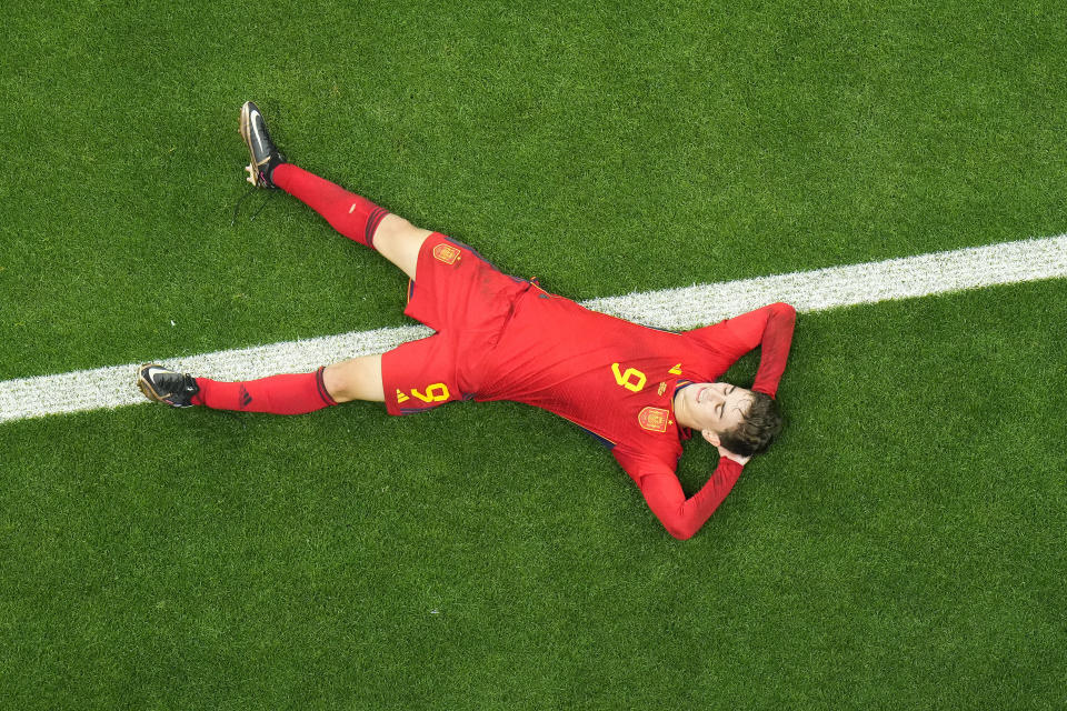 Spain's Gavi lays on the pitch during the World Cup group E soccer match between Spain and Germany, at the Al Bayt Stadium in Al Khor , Qatar, Sunday, Nov. 27, 2022. (AP Photo/Petr Josek)