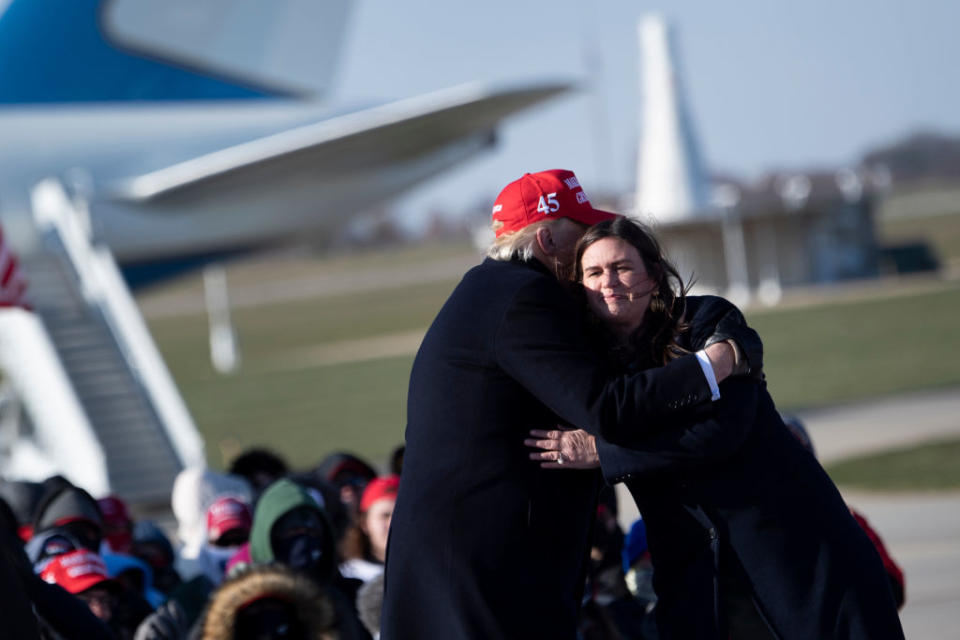 US President Donald Trump hugs his former press secretary Sarah Huckabee Sanders during a Make America Great Again rally at Dubuque Regional Airport.