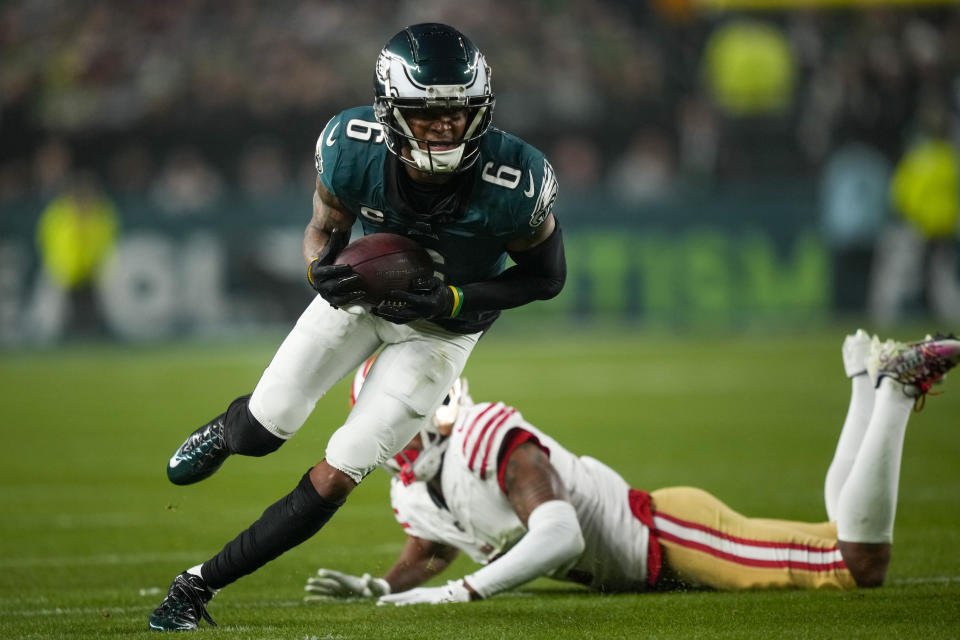 Philadelphia Eagles wide receiver DeVonta Smith (6) runs for yardage after avoiding a tackle by San Francisco 49ers cornerback Deommodore Lenoir during the first half of an NFL football game, Sunday, Dec. 3, 2023, in Philadelphia. (AP Photo/Matt Slocum)