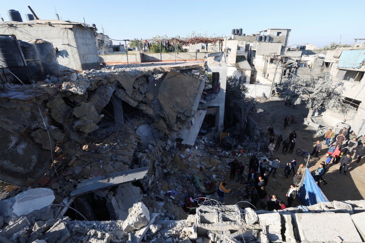 Palestinians inspect the site of an Israeli strike in Rafah, southern Gaza (Reuters)