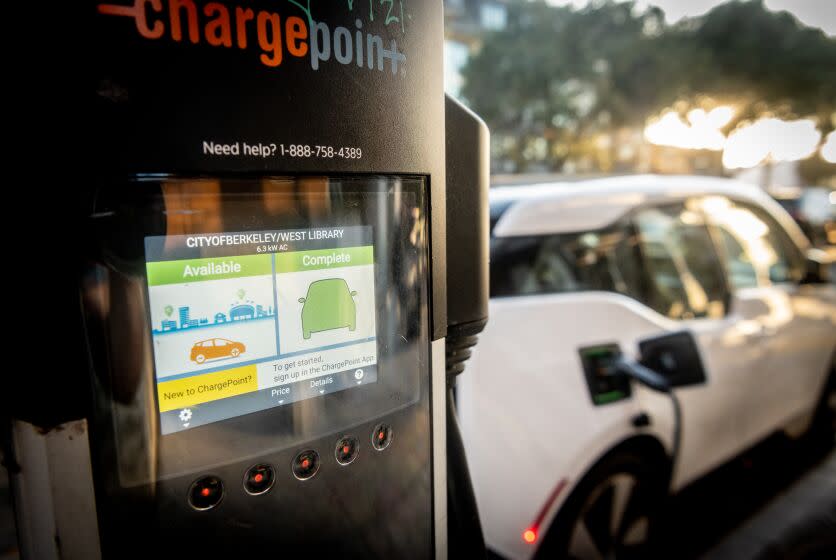 BERKELEY, CA - DECEMBER 01, 2021 - An electric vehicle charging station charges a vehicle with excess energy at the Berkeley Public Library West Branch in Berkeley, California on December 01, 2021. (Josh Edelson/for the Times)