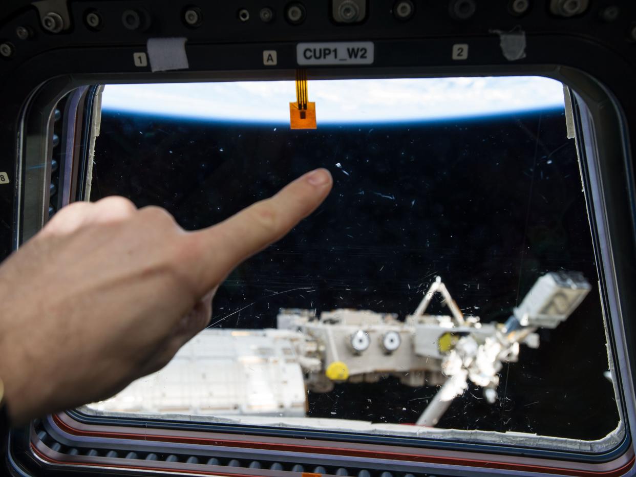 Small marks closeup were mistaken for distant unidentified flying objects from the ISS window (Nasa)