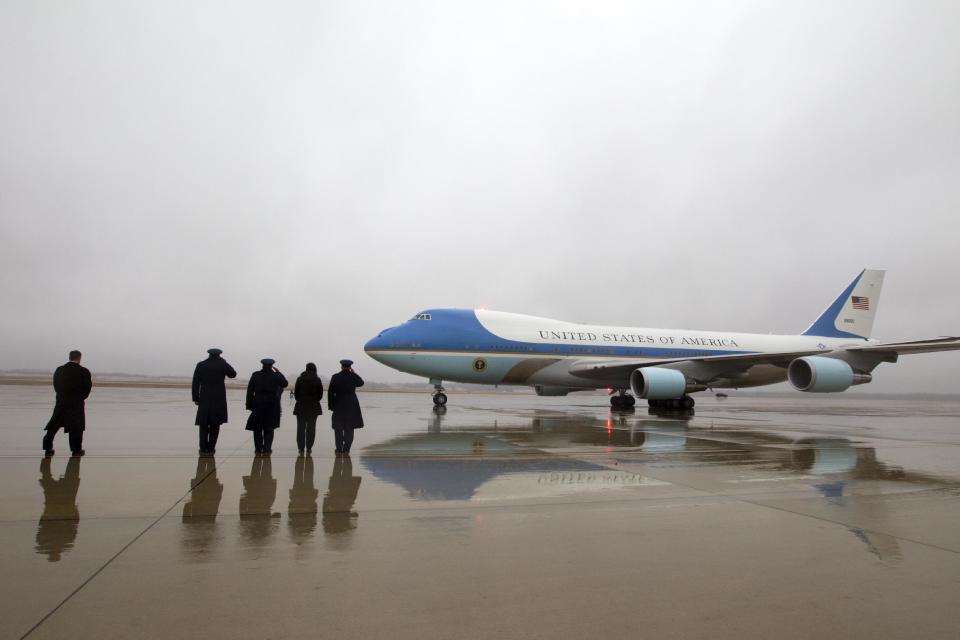 Military personnel salute as Air Force One with President Barack Obama and first family aboard arrives at Andrews Air Force Base, Md., Monday, Jan. 2, 2017. President and his family are returning from vacation in Hawaii. ( AP Photo/Jose Luis Magana)