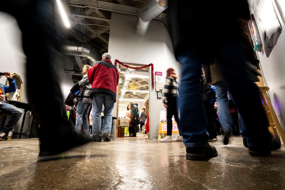 People walk past open studios during First Friday at Mainframe Studios last December.