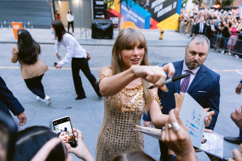 Toronto, Ont. - September 09: Taylor Swift greets fans before her conversation at Toronto International Film Festival 2022 outside the TIFF Bell Lightbox on Friday, Sept. 9, 2022 in Toronto, Ontario. (Wesley Lapointe / Los Angeles Times)