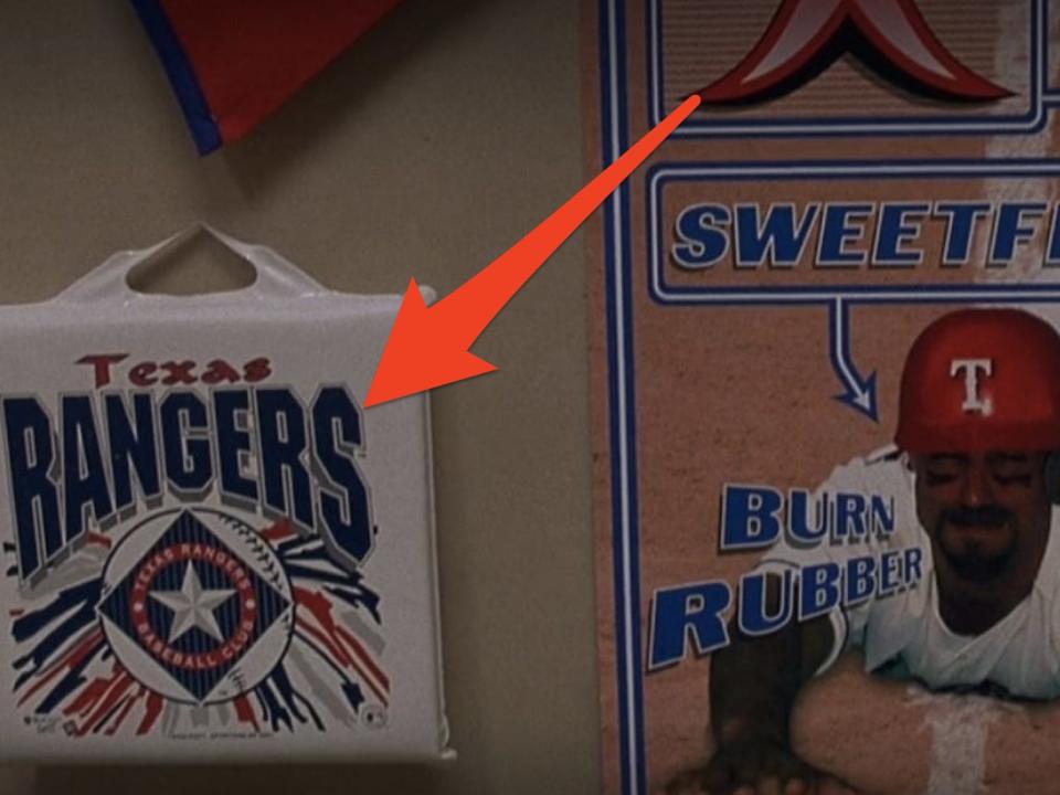 arrow pointing at texas rangers merch on stanley's bedroom wall in holes