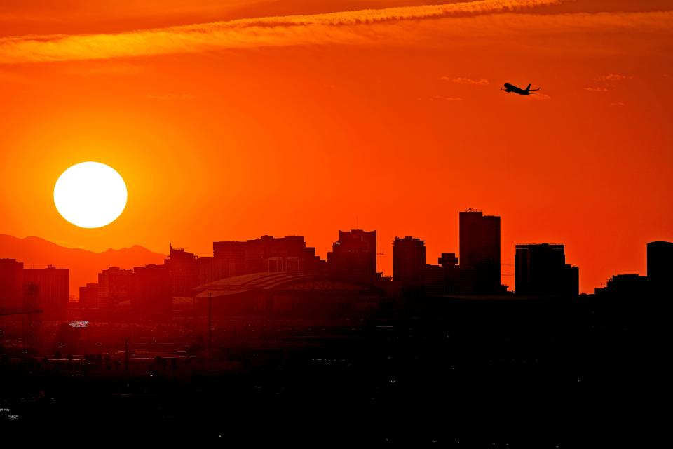 A Jet takes flight over downtown Phoenix on July 12, 2023, when the high hit 111 degrees. Nationwide, more than 113 million Americans were under some form of heat alert, the National Weather Service said. The alerts, which include excessive heat warnings and heat advisories, stretched 2,000 miles from Oregon to Louisiana.