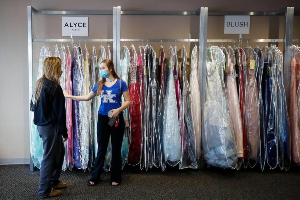 Megan Milton, a senior at Lexington Catholic, left, and Samantha Marnye, 17, a senior at Paul Laurence Dunbar, shop for prom dresses at Geno’s Formal Affair in Lexington, Thursday, May 13, 2021. Prom for all Fayette County schools will be held outdoors at various high schools on May, 22.