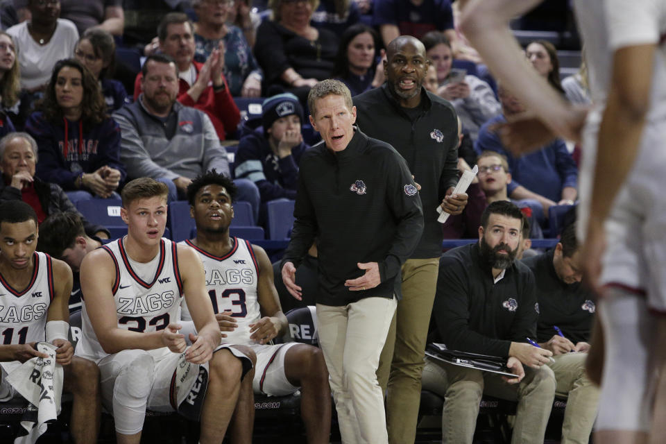 Gonzaga head coach Mark Few, center left, and assistant coach Roger Powell Jr., center right, direct the team during the first half of an NCAA college basketball game against Pepperdine, Saturday, Dec. 31, 2022, in Spokane, Wash. (AP Photo/Young Kwak)