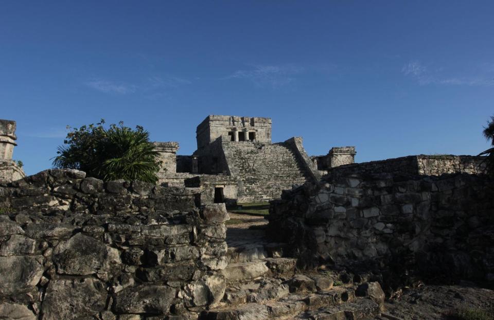 In this Jan. 4, 2013, photograph, the Castle of the Mayan ruins in Tulum, Mexico is lit by late afternoon sun. Tulum may be best-known for its ancient Mayan ruins, which attract a steady stream of day-trippers, cruise passengers and tour buses. The complex of crumbling structures here is smaller and less impressive than some other Mayan sites like Chichen Itza, but its location atop seaside cliffs is one of the most scenic ruin sites on the Yucatan. (AP Photo/Manuel Valdes)