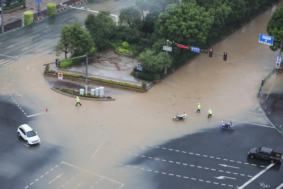 QUANZHOU, CHINA - JULY 28: Traffic police cordon off a flooded area as typhoon Doksuri brings strong winds and gales on July 28, 2023 in Quanzhou, Fujian Province of China. (Photo by Shi Yong/VCG via Getty Images)